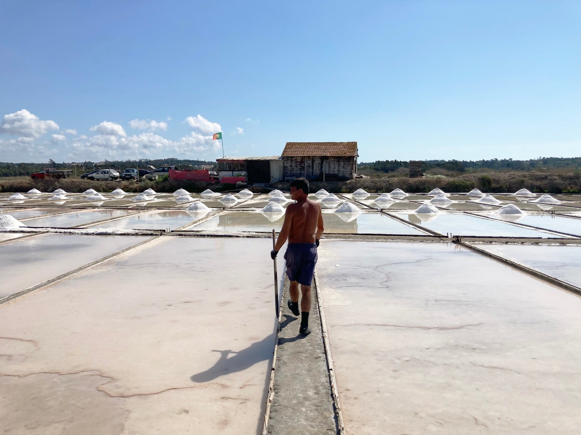 A salt producer walking the pans toward the barn, Figueira da Foz, Portugal